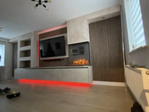 Professional media wall installation process showing the timber stud frame and hidden cable management systems.