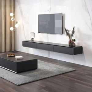 Close-up of bespoke floating shelves on a charcoal grey media wall showing hidden cable management.