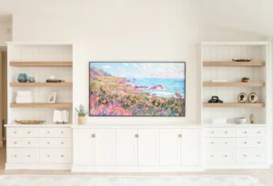 Minimalist media wall with custom floating cabinets and illuminated display shelving for an organized living space.